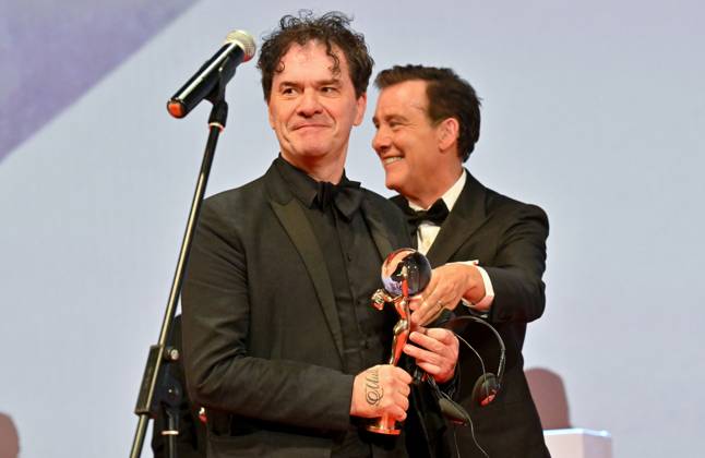 The British documentary Sudden Glimpse of Deeper Things by Mark Cousins (left) won the Grand Prix (Crystal Globe) in the main competition of the Karlovy Vary Film Festival today at the closing awards ceremony of the 58th Karlovy Vary International Film Festival, in Karlovy Vary, Czech Republic, on July 6, 2024. On the right is British actor Clive Owen. (CTKxPhoto OndrejxHajek) CTKPhotoP2024070605302  CTKPhotoP2024070605302