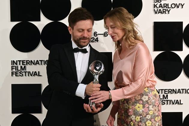 Director and actor Jiri Madl, left, and producer Monika Kristlova pose in front the photo wall with their Pravo Audience Award for the film Waves after the closing awards ceremony of the 58th Karlovy Vary International Film Festival, in Karlovy Vary, Czech Republic, on July 6, 2024. (CTKxPhoto SlavomirxKubes) CTKPhotoP2024070605421  CTKPhotoP2024070605421