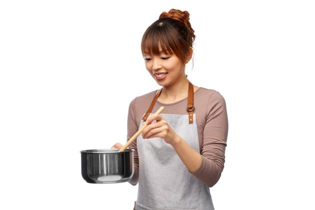 culinary and people concept - happy smiling female chef in jacket with saucepan cooking food over white background. happy smiling female chef with saucepan ,model released, Symbolfoto
