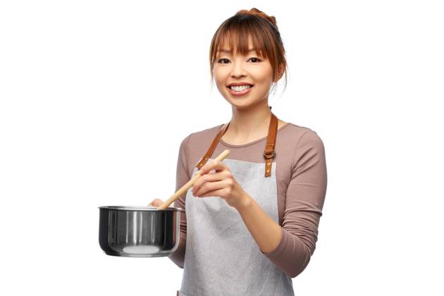 culinary and people concept - happy smiling female chef in jacket with saucepan cooking food over white background. happy smiling female chef with saucepan ,model released, Symbolfoto