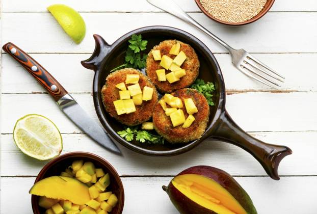 Vegan food, quinoa cutlet garnished with mango. Baked vegetarian burger. Vegetarian quinoa burgers ,model released, Symbolfoto