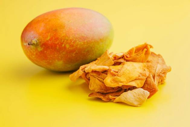  Dried mango fruit on yellow background., Dried mango fruit on the yellow background., Dried mango fruit on the yellow background., 13.12.2023, Copyright: xjirkaejcx Panthermedia36298252.jpg
