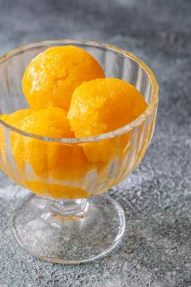  Mango sorbet bowl, Mango sorbet scoop in the glass bowl, Mango sorbet scoop in the glass bowl, 22.05.2024, Copyright: xAlex9500x Panthermedia37303374.jpg