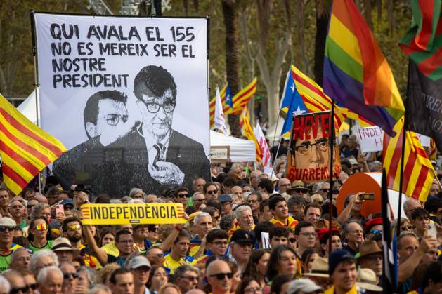 September 11, 2024, Barcelona, Spain: A man carries a sign with the word independence in front of a banner that says in Catalan Whoever approved 155 does not deserve to be our president with the face of the current President of the Generalitat of Catalonia, Salvador Illa (L) next to that of Pere Aragones (R), Illa s predecessor in office, to the right another protester carries a banner with the face of the former president of the generalitat, fugitive from justice, Carles Puigdemont, during the celebration of the Diada de Catalunya. As every September 11th, the Catalan National Day, also known as Catalonia Day or National Day of Catalonia, was celebrated in the city of Barcelona..In the morning, the traditional floral offering was made - ZUMAs197 20240911_aaa_s197_401 Copyright: xDavidxCanalesx