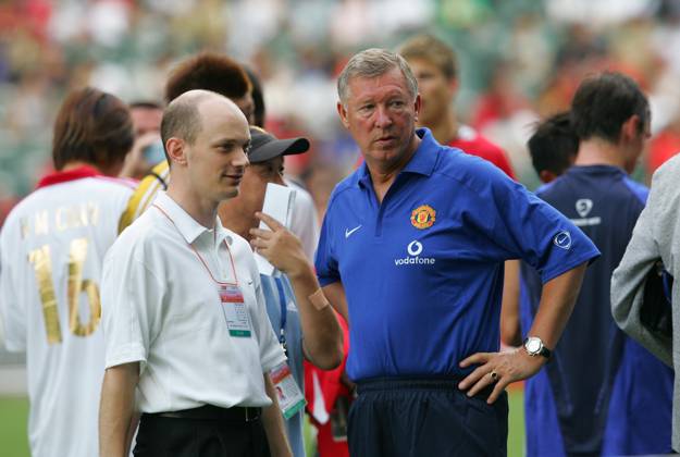 Sir Alex Ferguson, manager of Manchester United, talks to a team officer at the Hong Kong Stadium. Manchester United and the Hong Kong team played for the ING Manchester United Cup. 23 July 2005 Hong Kong China EDITORIAL USE ONLY Copyright: xx MPID4285727 K.xY.xChengx scmpphotos254668