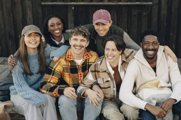 Portrait of happy multiracial male and female friends sitting with arm around each other Sweden, Gothenburg, model released, property released Copyright: xMaskotx , MA114973 MA114973