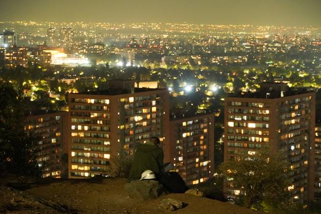 April 8, 2025, Santiago, Metropolitana, Chile: A man sits on a hill at night in Santiago, Chile. Santiago Chile - ZUMAb332 20250408_zip_b332_003 Copyright: xMatiasxBasualdox