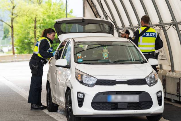 Grenzkontrolle der Bundespolizei an der Kontrollstelle Kiefersfelden, Inntal Ost, an der Autobahn A93 zwischen Deutschland und Österreich. Polizeibeamte bzw. Polizisten kontrollieren ein Fahrzeug in einem Kontrollzelt