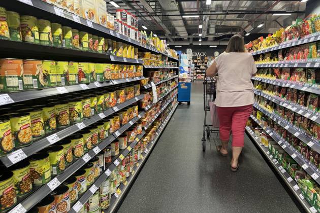 VERBRAUCHERPREISE: Inflation in Deutschland Eine Frau beim Einkaufen in einem Supermarkt, Preisschild,Preisaushang,Kuehltheke, Einkaufswagen, Einkauf,Inflation,Verbraucherpreise,Teuerung,