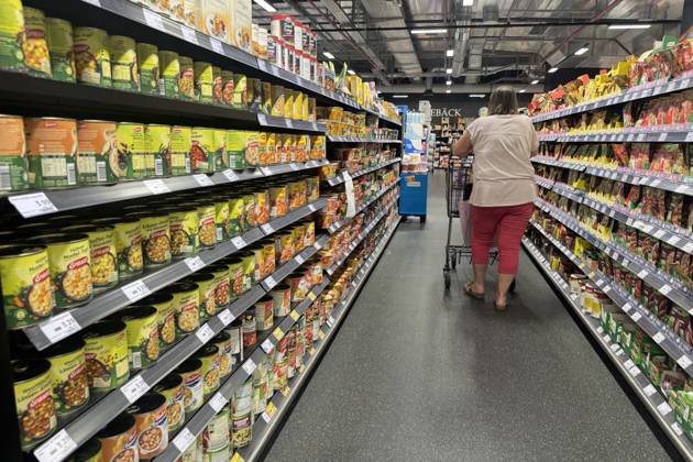 VERBRAUCHERPREISE: Inflation in Deutschland Eine Frau beim Einkaufen in einem Supermarkt, Preisschild,Preisaushang,Kuehltheke, Einkaufswagen, Einkauf,Inflation,Verbraucherpreise,Teuerung,