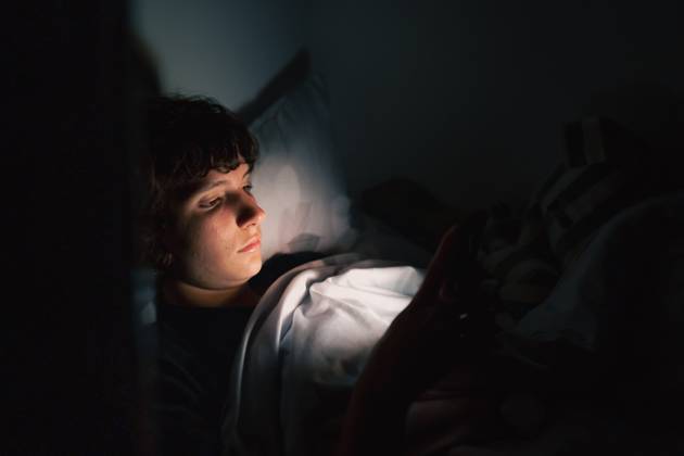 Teenager benutzt Gadget im Dunkeln teenager uses gadget in dark. Teen girl, lying under covers in bed, uses mobile phone, at night (License=RF) ,model released, Symbolfoto Copyright: xZoonar.com LarysaxStefaniukx 23623617 ,model released, Symbolfoto ,property released