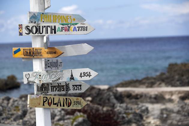 Country distance sign, showing the direction and distance to countries around the world. Cayman Islands. Cayman Islands