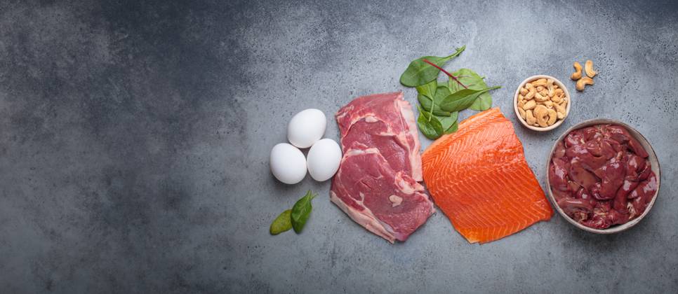 Food ingredients high in iron for health and wellness top view on grey concrete background Fresh salmon fillet, raw beef, nutritious eggs, spinach, nuts cashews and liver arranged on a gray background, iron rich foods essential for a balanced diet concept, 63574864.jpg RECORD DATE NOT STATED