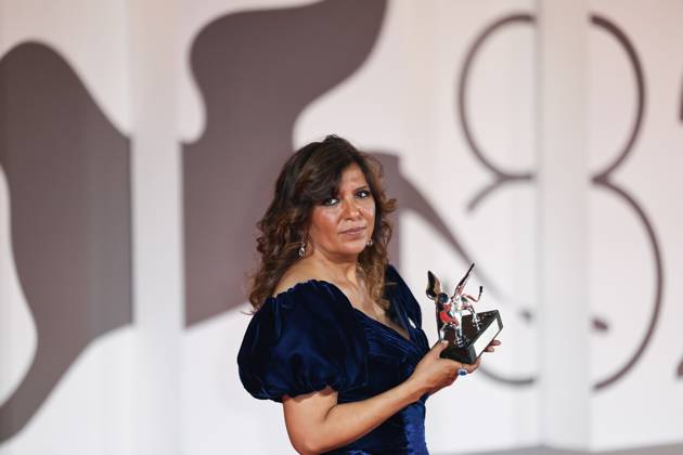(250907) -- VENICE, Sept. 7, 2025 -- Tunisian director Kaouther Ben Hania poses with the trophy at the 82nd Venice International Film Festival in Venice, Italy, Sept. 6, 2025. Tunisian director Kaouther Ben Hania s The Voice of Hind Rajab, a film about a Palestinian girl killed in the Gaza conflict, took home the Grand Jury Prize. The 82nd edition of the Venice International Film Festival ran from Aug. 27 to Sept. 6 at the Lido island of the Italian lagoon city, with 21 films in the main competition lineup. ) ITALY-VENICE-FILM FESTIVAL-AWARDING CEREMONY LixJing 