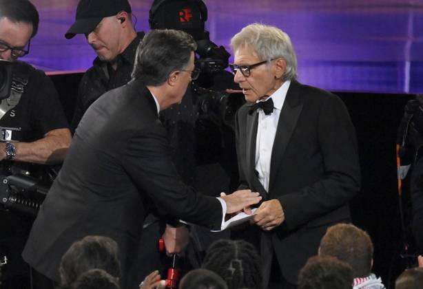 Stephen Colbert speaks to Harrison Ford at the 77th annual Primetime Emmy Awards at the Peacock Theater in Los Angeles on Sunday, September 14, 2025.  LAP202509142001 JIMxRUYMEN