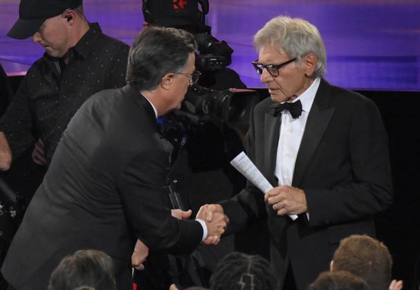 Stephen Colbert speaks to Harrison Ford at the 77th annual Primetime Emmy Awards at the Peacock Theater in Los Angeles on Sunday, September 14, 2025.  LAP202509142002 JIMxRUYMEN