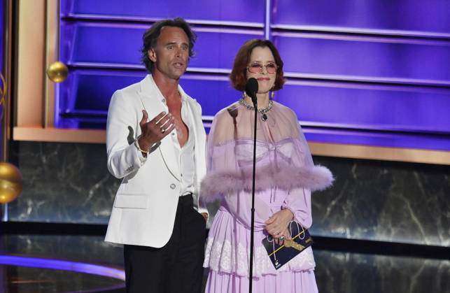 Walton Goggins and Parker Posey speak onstage at the 77th annual Primetime Emmy Awards at the Peacock Theater in Los Angeles on Sunday, September 14, 2025.  LAP202509148030 JIMxRUYMEN