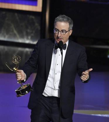 John Oliver (C) accepts the Outstanding Scripted Variety Series award for Last Week Tonight with John Oliver onstage at the 77th annual Primetime Emmy Awards at the Peacock Theater in Los Angeles on Sunday, September 14, 2025.  LAP2025091480486 JIMxRUYMEN
