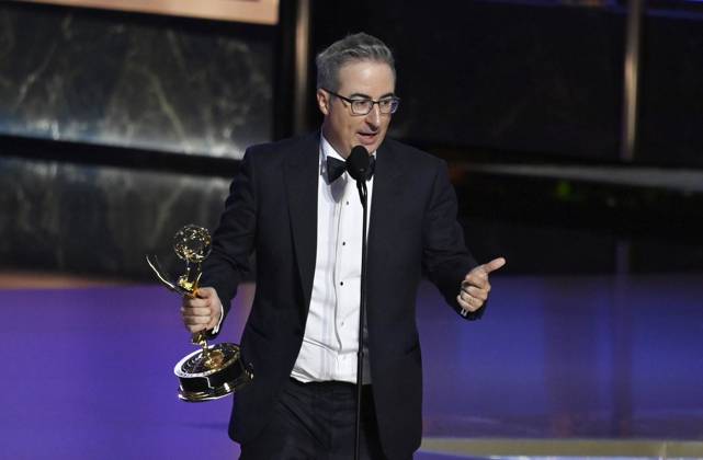John Oliver (C) accepts the Outstanding Scripted Variety Series award for Last Week Tonight with John Oliver onstage at the 77th annual Primetime Emmy Awards at the Peacock Theater in Los Angeles on Sunday, September 14, 2025.  LAP2025091480487 JIMxRUYMEN