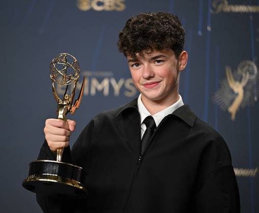 Owen Cooper holds the Emmy for Outstanding Supporting Actor in a Limited or Anthology Series or Movie for Adolescence, backstage during the 77th annual Primetime Emmy Awards at the Peacock Theater in Los Angeles on Sunday, September 14, 2025.  LAP20250914185 CHISxCHEW