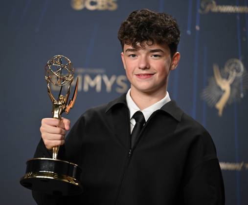 Owen Cooper holds the Emmy for Outstanding Supporting Actor in a Limited or Anthology Series or Movie for Adolescence, backstage during the 77th annual Primetime Emmy Awards at the Peacock Theater in Los Angeles on Sunday, September 14, 2025.  LAP20250914186 CHISxCHEW
