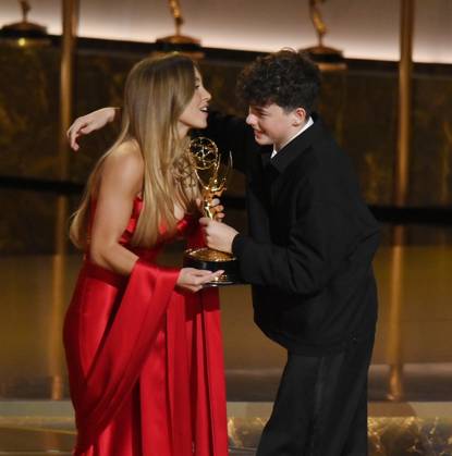 Sydney Sweeney presents the Outstanding Supporting Actor in a Limited or Anthology Series or Movie award for Adolescence to Owen Cooper onstage during at the 77th annual Primetime Emmy Awards at the Peacock Theater in Los Angeles on Sunday, September 14, 2025.  LAP20250914900 JIMxRUYMEN
