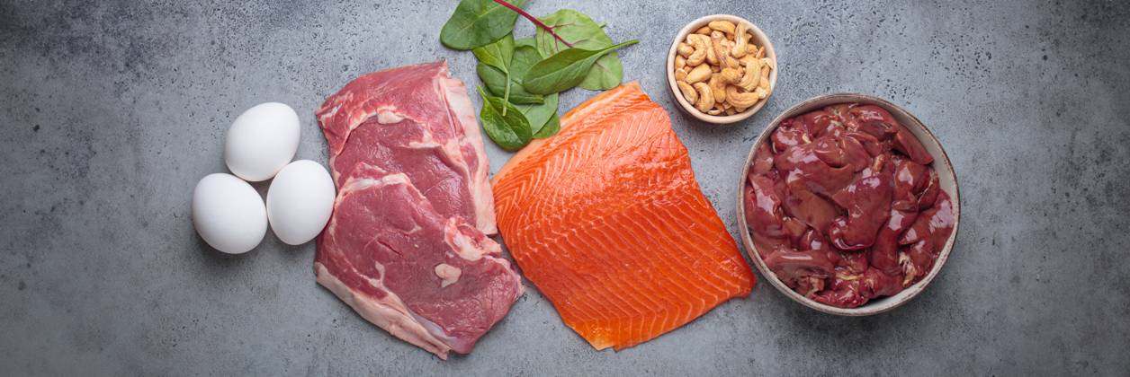 Food ingredients high in iron for health and wellness top view on grey concrete background Fresh salmon fillet, raw beef, nutritious eggs, spinach, nuts cashews and liver arranged on a gray background, iron rich foods essential for a balanced diet concept, 94607570.jpg RECORD DATE NOT STATED
