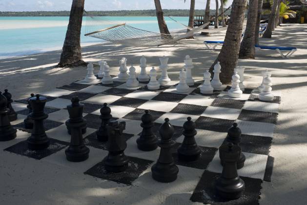 Cook Islands in the South Pacific Aitutaki. Cook Island. Polynesia. South Pacific Ocean. Giant chess set on the beach of the Aitutaki Lagoon Resort & Spa Hotel. With a lagoon that is arguably one of the most beautiful in the world, a cruise out on its pristine water is an absolute must. You are likely to be so enchanted, that you ll book another tour for the next day. Back on land, the island of Aitutaki has an interesting history and there are excavations of local marae underway. You can take a safari tour to these ancient places, explore the island and also find out about the legacy of the American troops stationed here during WWII. For novice scooter riders, Aitutaki is generally safer than Rarotonga where traffic can be quite busy at ti Copyright: xSergixReboredox