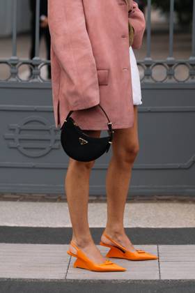 RECORD DATE NOT STATED Milan, Italy - September, 21, 2023: woman wears orange brushed leather pumps, high heels from Prada and shoulder bag Milan, Italy - September, 21, 2023: woman wears orange brushed leather pumps, high heels from Prada and shoulder bag, street style accessories, 96472744.jpg