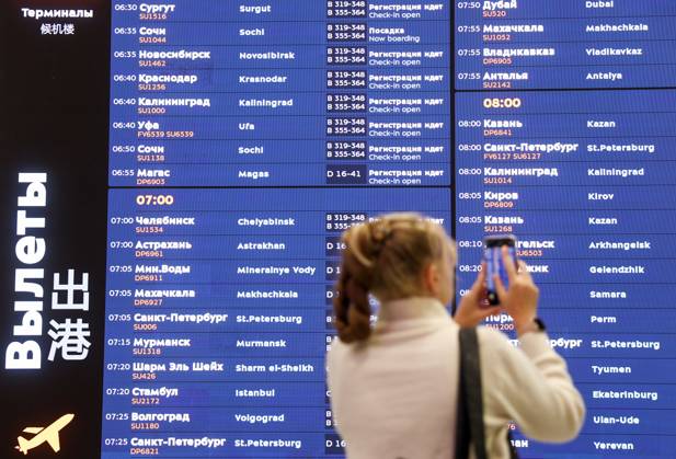 RUSSIA, MOSCOW REGION - SEPTEMBER 17, 2025: A woman takes pictures of a flight information display board as an Aeroflot flight prepares to depart from Sheremetyevo International Airport to Krasnodar. On 11 September 2025, Krasnodar International Airport resumed operations, with the first civil flight since 2022 expected to land there on September 17. Sofya Sandurskaya TASS  84063520