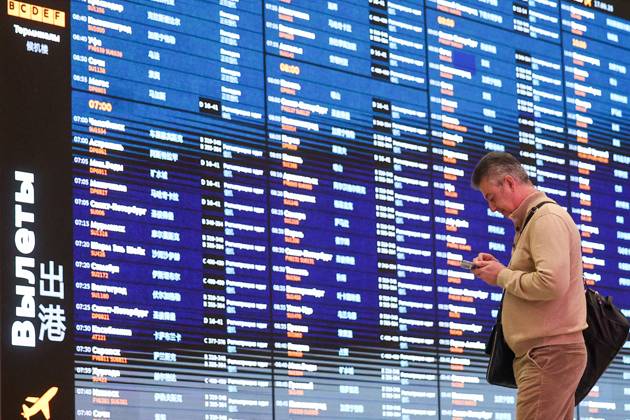 RUSSIA, MOSCOW REGION - SEPTEMBER 17, 2025: A man stands before a flight information display board at Sheremetyevo International Airport. Sofya Sandurskaya TASS  84063955