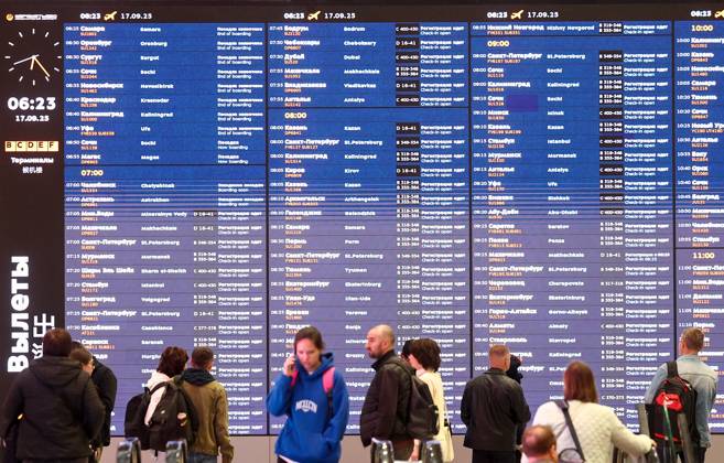 RUSSIA, MOSCOW REGION - SEPTEMBER 17, 2025: Travelers read a flight information display board at Sheremetyevo International Airport. Sofya Sandurskaya TASS  84063987