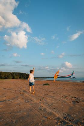 Child running with kite on sandy beach, getting away from it all Primorsk, Leningrad Oblast, Russia CR_KSLI25092570-1832547-01 ,model released, Symbolfoto