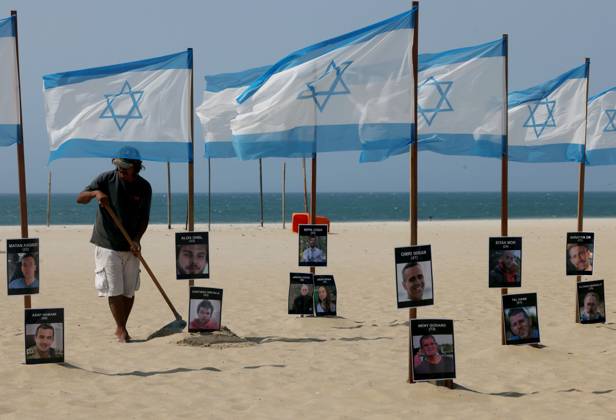 October 7, 2025, Rio De Janeiro, Rio De Janeiro, Brazil: Rio de Paz, a Brazilian human rights NGO known for its symbolic public demonstrations installed 22 Israeli flags and photos of 48 hostages on Copacabana Beach in a demonstration against terrorism and in solidarity with the victims of the Hamas attack on October 7, 2023, marking two years since the attacks on Israel. The act denounced terrorism and called for the release of hostages still held in Gaza. Rio De Janeiro Brazil - ZUMAk251 20251007_znp_k251_003 Copyright: xBobxKarpx