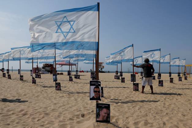 October 7, 2025, Rio De Janeiro, Rio De Janeiro, Brazil: Rio de Paz, a Brazilian human rights NGO known for its symbolic public demonstrations installed 22 Israeli flags and photos of 48 hostages on Copacabana Beach in a demonstration against terrorism and in solidarity with the victims of the Hamas attack on October 7, 2023, marking two years since the attacks on Israel. The act denounced terrorism and called for the release of hostages still held in Gaza. Rio De Janeiro Brazil - ZUMAk251 20251007_znp_k251_008 Copyright: xBobxKarpx