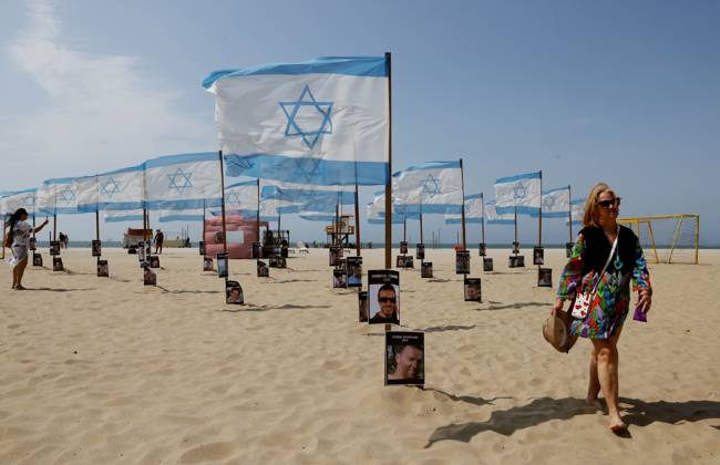 October 7, 2025, Rio De Janeiro, Rio De Janeiro, Brazil: Rio de Paz, a Brazilian human rights NGO known for its symbolic public demonstrations installed 22 Israeli flags and photos of 48 hostages on Copacabana Beach in a demonstration against terrorism and in solidarity with the victims of the Hamas attack on October 7, 2023, marking two years since the attacks on Israel. The act denounced terrorism and called for the release of hostages still held in Gaza. Rio De Janeiro Brazil - ZUMAk251 20251007_znp_k251_012 Copyright: xBobxKarpx