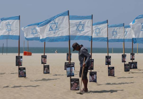 October 7, 2025, Rio De Janeiro, Rio De Janeiro, Brazil: Rio de Paz, a Brazilian human rights NGO known for its symbolic public demonstrations installed 22 Israeli flags and photos of 48 hostages on Copacabana Beach in a demonstration against terrorism and in solidarity with the victims of the Hamas attack on October 7, 2023, marking two years since the attacks on Israel. The act denounced terrorism and called for the release of hostages still held in Gaza. Rio De Janeiro Brazil - ZUMAk251 20251007_znp_k251_005 Copyright: xBobxKarpx