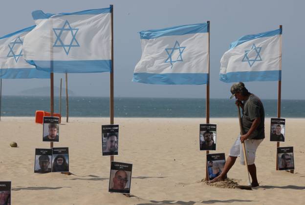 October 7, 2025, Rio De Janeiro, Rio De Janeiro, Brazil: Rio de Paz, a Brazilian human rights NGO known for its symbolic public demonstrations installed 22 Israeli flags and photos of 48 hostages on Copacabana Beach in a demonstration against terrorism and in solidarity with the victims of the Hamas attack on October 7, 2023, marking two years since the attacks on Israel. The act denounced terrorism and called for the release of hostages still held in Gaza. Rio De Janeiro Brazil - ZUMAk251 20251007_znp_k251_013 Copyright: xBobxKarpx