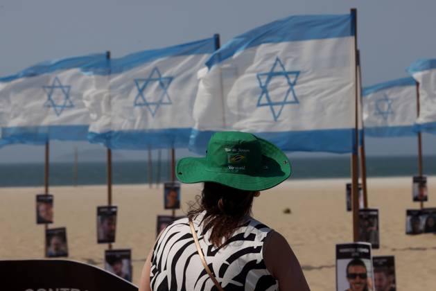 October 7, 2025, Rio De Janeiro, Rio De Janeiro, Brazil: Rio de Paz, a Brazilian human rights NGO known for its symbolic public demonstrations installed 22 Israeli flags and photos of 48 hostages on Copacabana Beach in a demonstration against terrorism and in solidarity with the victims of the Hamas attack on October 7, 2023, marking two years since the attacks on Israel. The act denounced terrorism and called for the release of hostages still held in Gaza. Rio De Janeiro Brazil - ZUMAk251 20251007_znp_k251_017 Copyright: xBobxKarpx