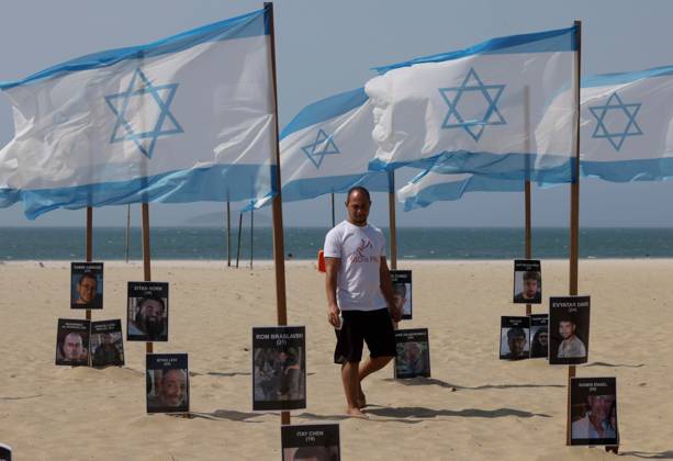 October 7, 2025, Rio De Janeiro, Rio De Janeiro, Brazil: Rio de Paz, a Brazilian human rights NGO known for its symbolic public demonstrations installed 22 Israeli flags and photos of 48 hostages on Copacabana Beach in a demonstration against terrorism and in solidarity with the victims of the Hamas attack on October 7, 2023, marking two years since the attacks on Israel. The act denounced terrorism and called for the release of hostages still held in Gaza. Rio De Janeiro Brazil - ZUMAo Pr 20251007_znp_k251_011 Copyright: xBobxKarpx