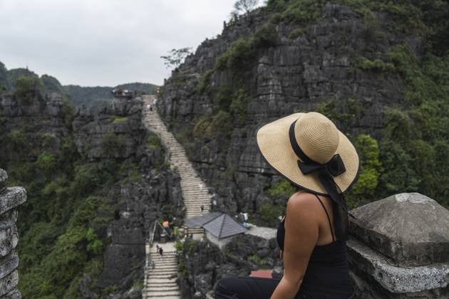 Tourist with hat overlooking green mountains at Ninh Vinh Vietnam model released, Symbolfoto property released, PNAF06762