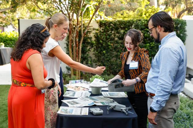 October 23, 2025, St. Petersburg, Florida, USA: Tampa Bay Times newsroom staff, Colleen Wright, Nina Moske, Claire McNeill, Emily Mahoney, and Max Chesnes place newspapers on a table during the annual Cocktails and News fundraiser event on Thursday, Oct. 23, 2025, in St. Petersburg. St. Petersburg USA - ZUMAs70_ 20251023_zan_s70_057 Copyright: xJeffereexWoox