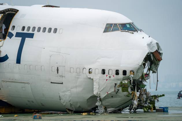 Hong Kong Plane Accident Wreckage The main fuselage section of an ACT Airlines Boeing 747-400 cargo aircraft which skidded off the runway while landing on at Hong Kong International Airport on a flat deck barge on October 28, 2025 in Hong Kong. The Boeing 747 skidded off the runway while landing at Hong Kong International Airport killing two on the ground in a security guard vehicle. (Photo by Vernon Yuen Nexpher Images) Hong Kong