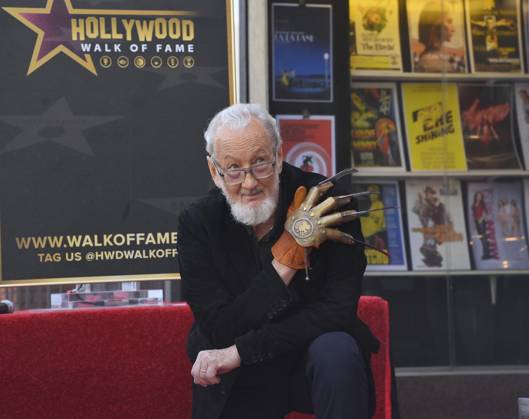 American actor and director Robert Englund, who is best known for his portrayal of the villainous Freddie Krueger kneels next to his star during an unveiling ceremony honoring him with the 2, 826th star on the Hollywood Walk of Fame in Los Angeles on Friday, October 31, 2025.  LAP2025103113 JIMxRUYMEN