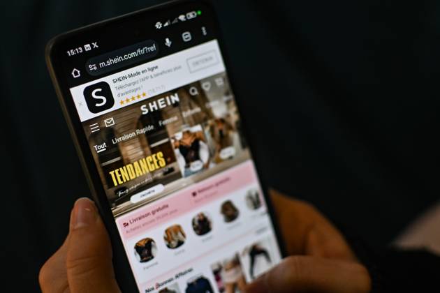 November 11, 2025, Clermont-Ferrand, Auvergne Rhone Alpes, France: A woman scrolls on a phone on Shein online store in Clermont-Ferrand, France, on November 11, 2025. The government still wants to get the Chinese platform suspended in France, where it is facing several legal proceedings. A procedure to suspend the Chinese giant has been initiated in France, a decision taken after the scandal involving child pornography sex dolls. Clermont-Ferrand France - ZUMAf173 20251111_zip_f173_005 Copyright: xAdrienxFillonx