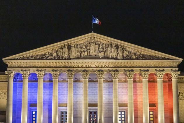 Paris, France November 13, 2025 - A flag flies atop the roof of the Palais Bourbon, seat of the National Assembly, as it is illuminated in the colours of the French flag during the commemoration of the tenth anniversary of the Paris terrorist attack. On Friday, November 13, 2015, three heavily armed Islamic State (IS) militants stormed the Bataclan concert hall in Paris during a performance by the American rock band Eagles of Death Metal, killing 90 people and taking hostages. The attack was the deadliest in a series of coordinated assaults across Paris that night, which left a total of 130 people dead. HOMMAGE ATTAQUES TERRORISTES, ILLUSTRATION, MONUMENT, ECLAIRAGE, ILLUMINATIONS, DRAPEAU FRANCAIS, TRICOLORE, ASSEMBLEE NATIONALE, PALAIS B Copyright: xVincentxIsorex