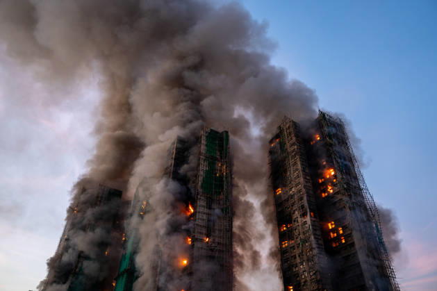 Hong Kong Building Fire Smoke and flames rise as a major fire engulfs several residential buildings at Wang Fuk Court on November 26, 2025 in Hong Kong. Serval residential building in Wang Fuk Court located in Tai Po District caught fire today, the Hong Kong Fire Department has issued the No.5 fire alarm, the fire at local time 1800 has claimed the life of one firefighter and three other people. (Photo by Vernon Yuen Nexpher Images) Hong Kong