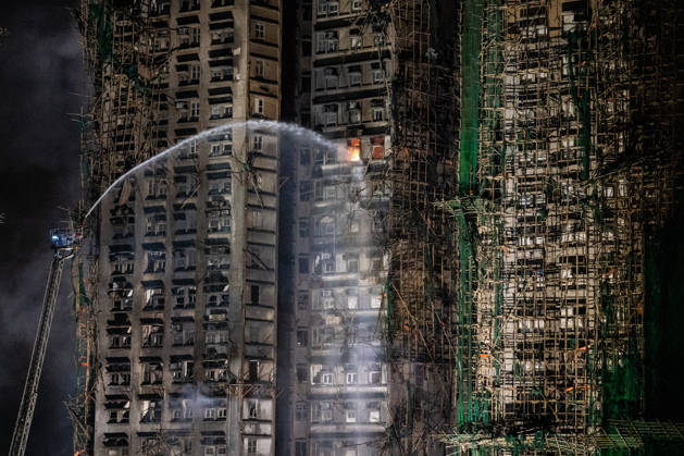 Hong Kong Building Fire A firetruck ladder spraying water onto the apartment building where a major fire engulfs several residential buildings at Wang Fuk Court on November 27, 2025 in Hong Kong. Serval residential building in Wang Fuk Court located in Tai Po District caught fire today, the Hong Kong Fire Department has issued the No.5 fire alarm, the fire at local time 2000 - 65 Dead. (Photo by Vernon Yuen Nexpher Images) Hong Kong