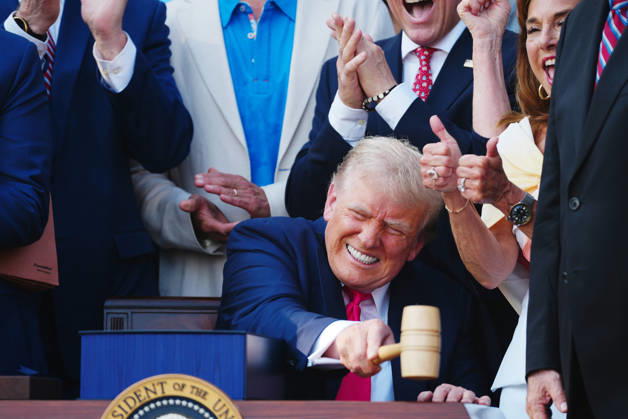 President Donald Trump strikes a gavel from Speaker of the House Mike Johnson, R-LA, after signing a new tax and immigration bill during a ceremony at the White House in Washington DC, on Friday, July 4, 2025. The bill extends tax cuts from 2017, increases funding for defense and immigration security and cuts nearing $1 trillion from Medicaid.  POY2025DC012 BONNIExCASH