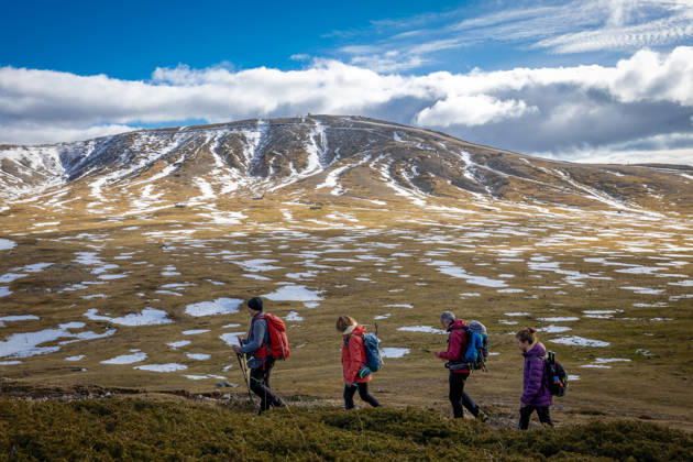 Hikers on a mountain trail. Guarcino (FR), Italy - December 21, 2025: A group of hikers in single file walk along a mountain trail, with the partially snow-capped peaks of the Lazio Apennines in the background. Guarcino FR Italy Copyright: xGennaroxLeonardix